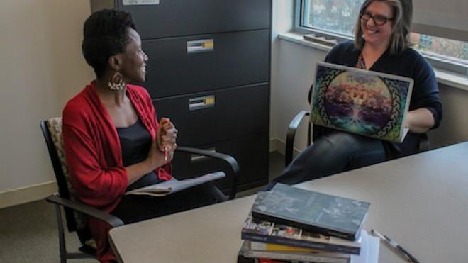 Two faculty members have a discussion. 